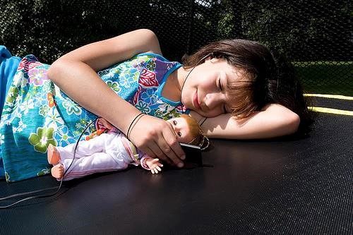 Girl lying on trampoline